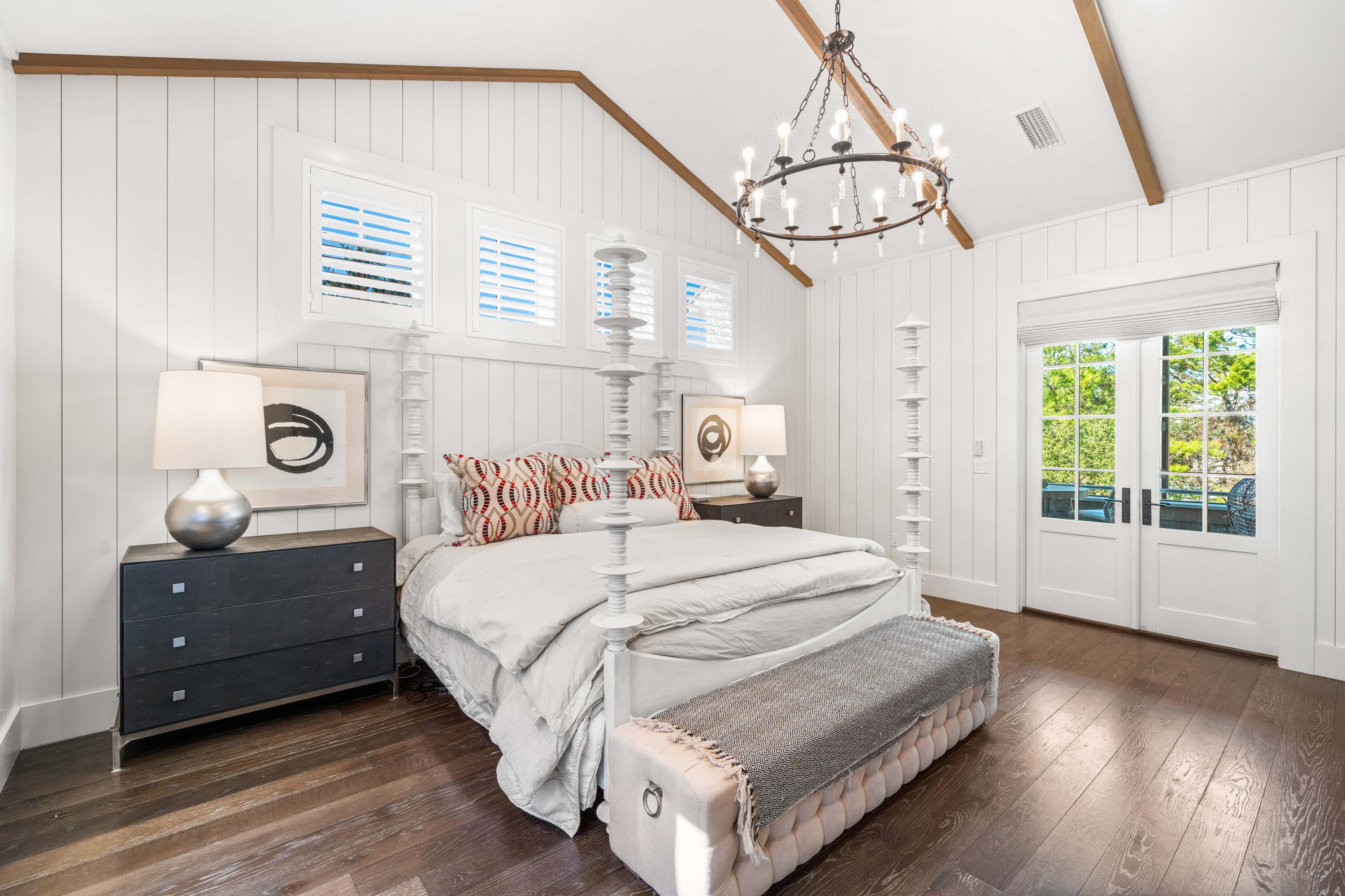 47 Compass Point Way Inlet Beach, FL 32461 - Photo 25 of 50 a bedroom with a bed and a chandelier