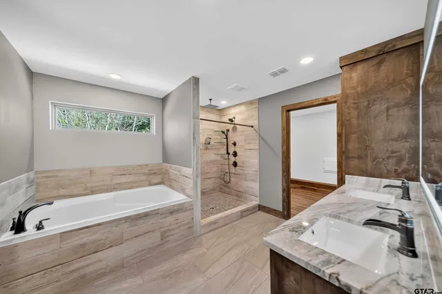 a bathroom with a tub and a sink