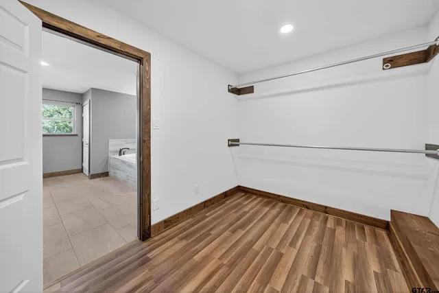 a view of a room with wooden floor