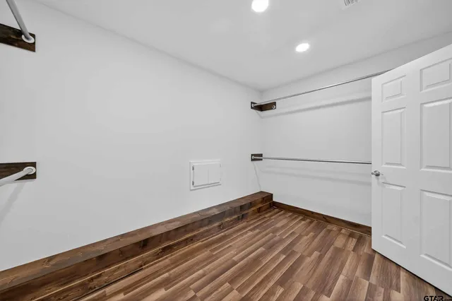 a bedroom with a bed lamps and table