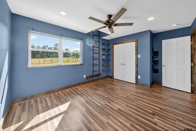 a bed room with a bed and a chair