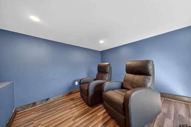 a bathroom with a sink a toilet and a large mirror