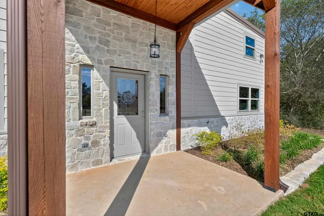 a view of a house with potted plants