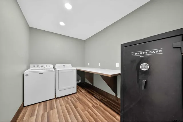 a view of a room with wooden floor and ceiling fan