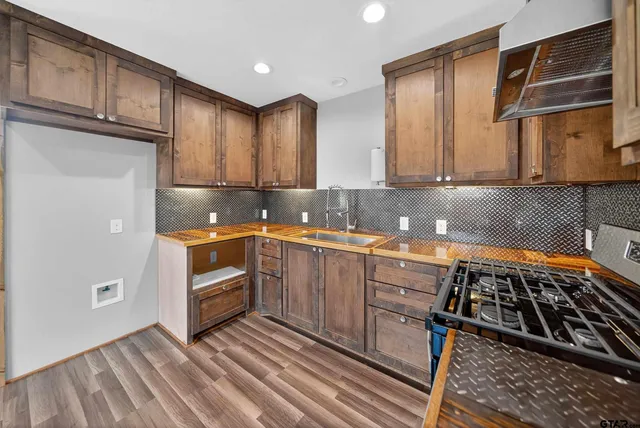 a kitchen with granite countertop a stove and a sink