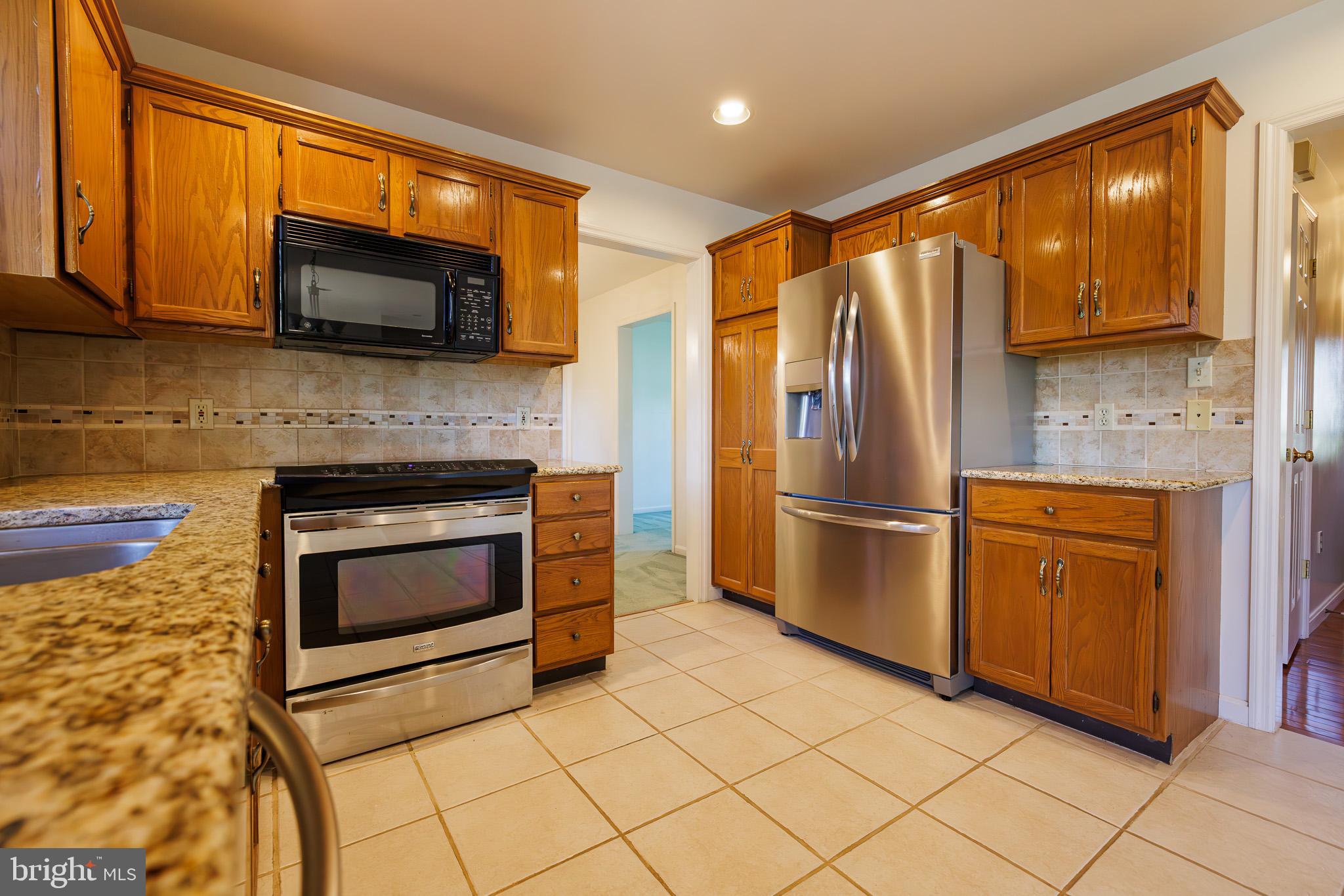 280 Raspberry Road Leola, PA 17540 - Photo 1 of 41 a kitchen with granite countertop a refrigerator and a stove top oven