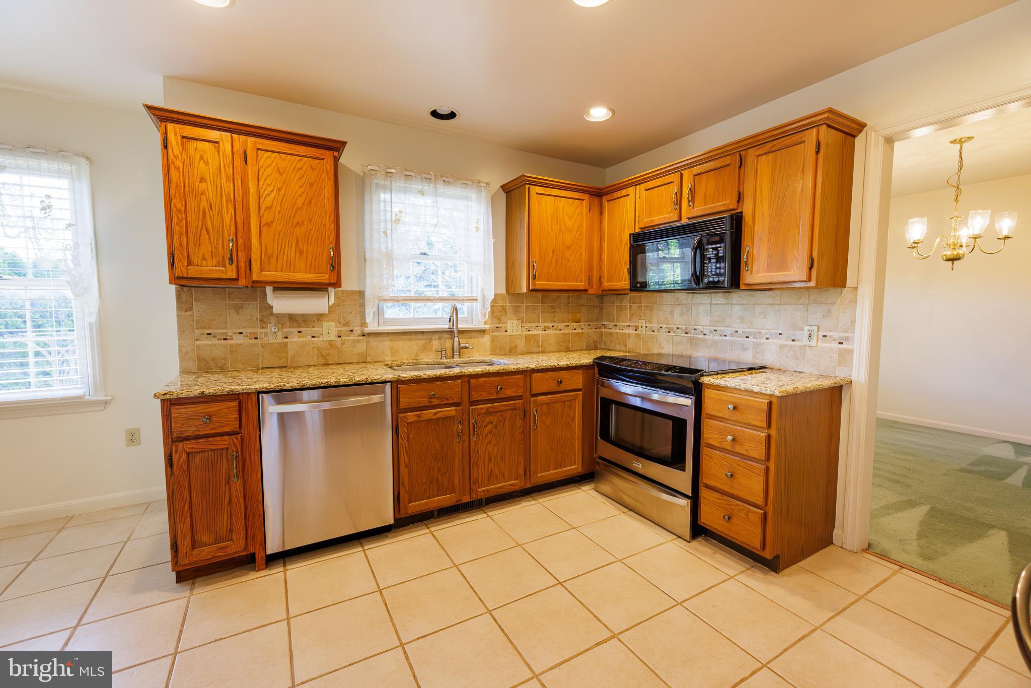 280 Raspberry Road Leola, PA 17540 - Photo 12 of 41 a kitchen with stainless steel appliances granite countertop a stove a sink and a microwave