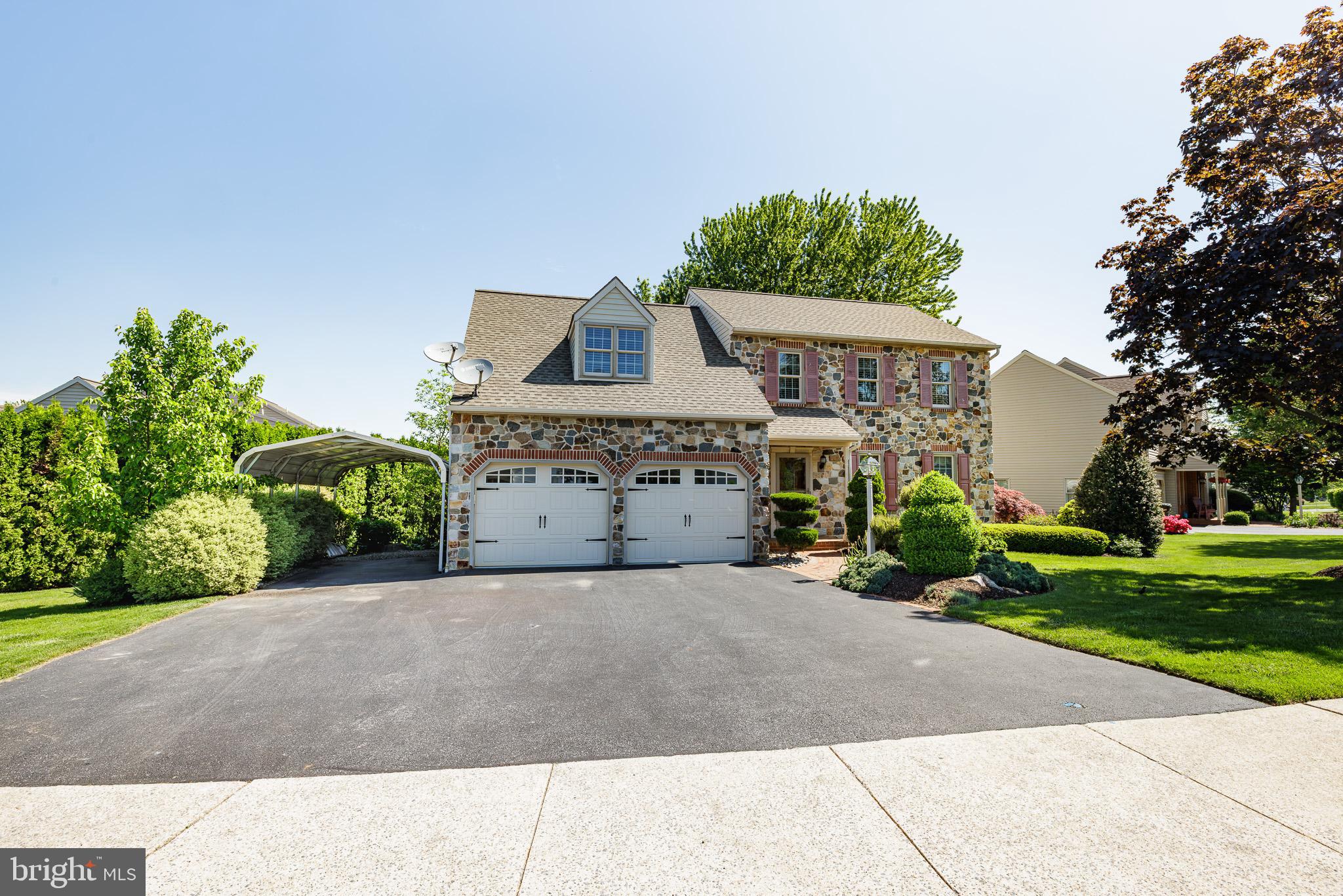 280 Raspberry Road Leola, PA 17540 - Photo 2 of 41 a front view of a house with a yard and garage