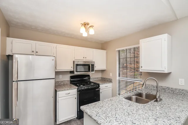 a kitchen with a refrigerator stove and sink