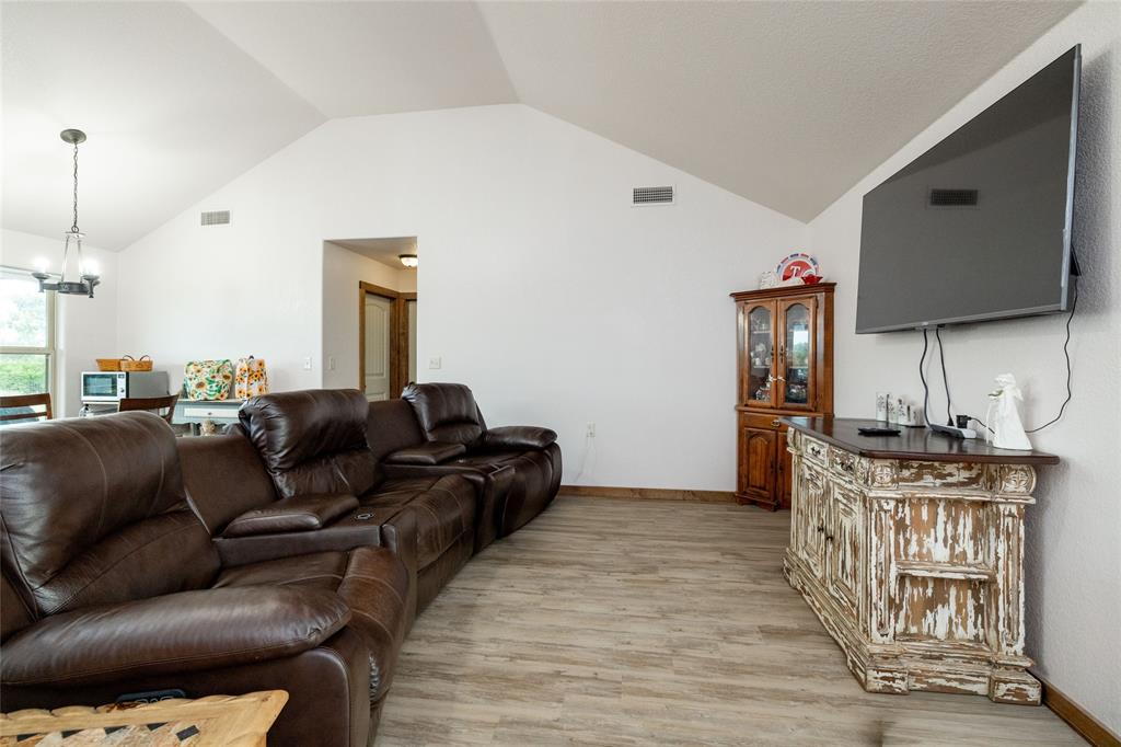 493 Browning Road Bellevue, TX 76228 - Photo 3 of 33 a living room with furniture and a flat screen tv
