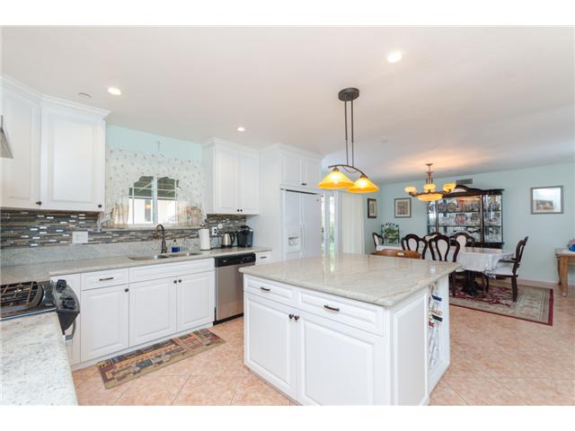 8859 Los Coches Road Lakeside, CA 92040 - Photo 7 of 25 This spacious kitchen and island are perfect for entertaining. The dining room is in the background.
