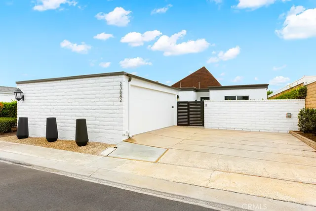 a backyard of a house with a fountain swing table and chairs