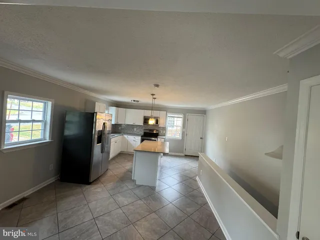 a view of a living room hardwood floor and a window