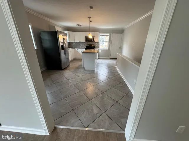 a view of a kitchen from the hallway