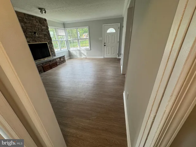 a view of a livingroom with wooden floor and a window