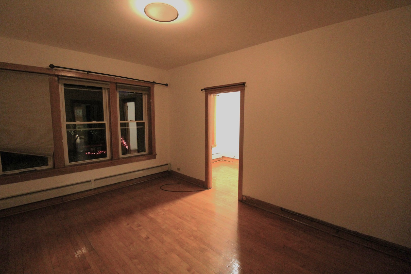 2132 West Walton Street, Unit 2 Chicago, IL 60622 - Photo 5 of 12 a view of an empty room with wooden floor and a window