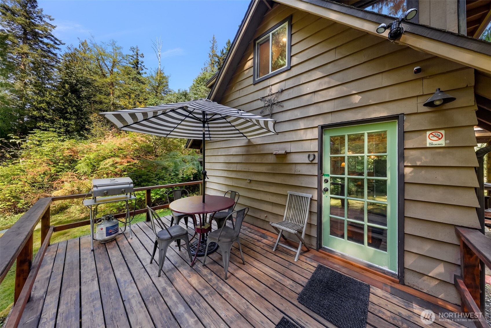 9778 Mt Baker Highway Deming, WA 98244 - Photo 27 of 40 a view of a patio with table and chairs with wooden floor and fence