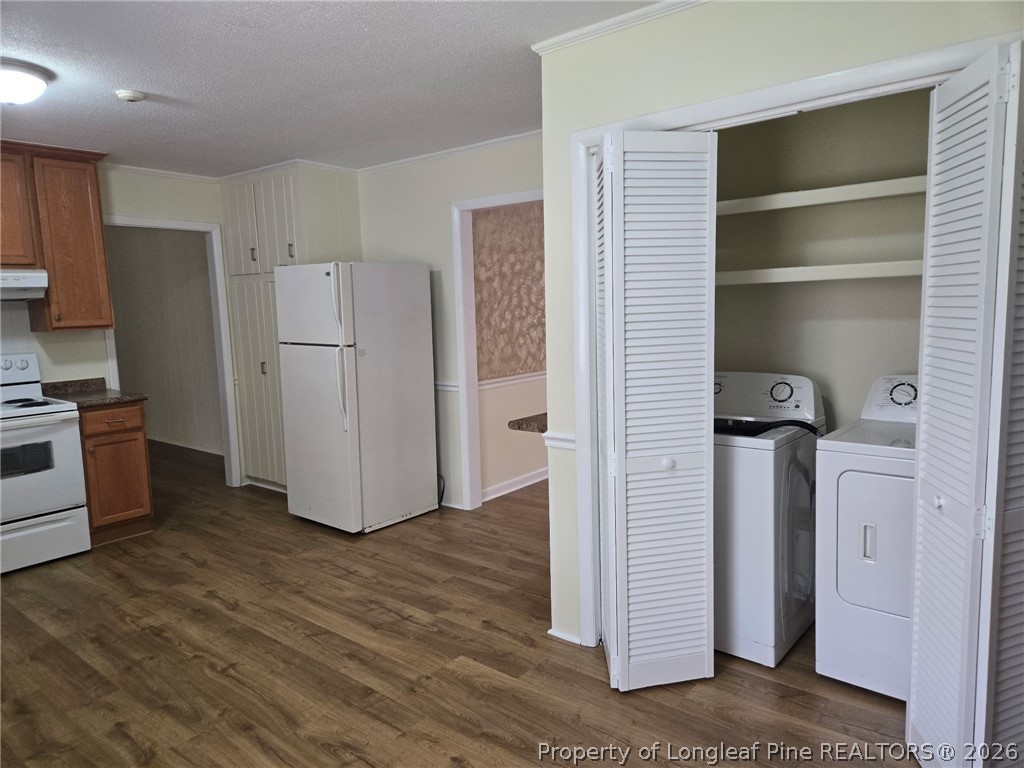 425 Dunmore Road Fayetteville, NC 28303 - Photo 10 of 21 a view of a kitchen with refrigerator and wooden floor
