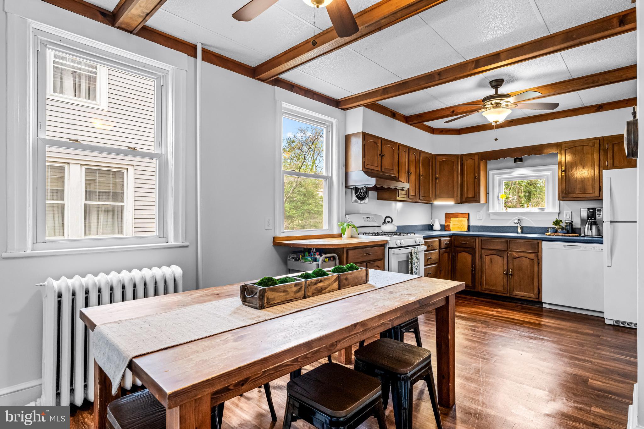 403 Midway Riverton, NJ 08077 - Photo 21 of 53 a kitchen with a dining table chairs and window