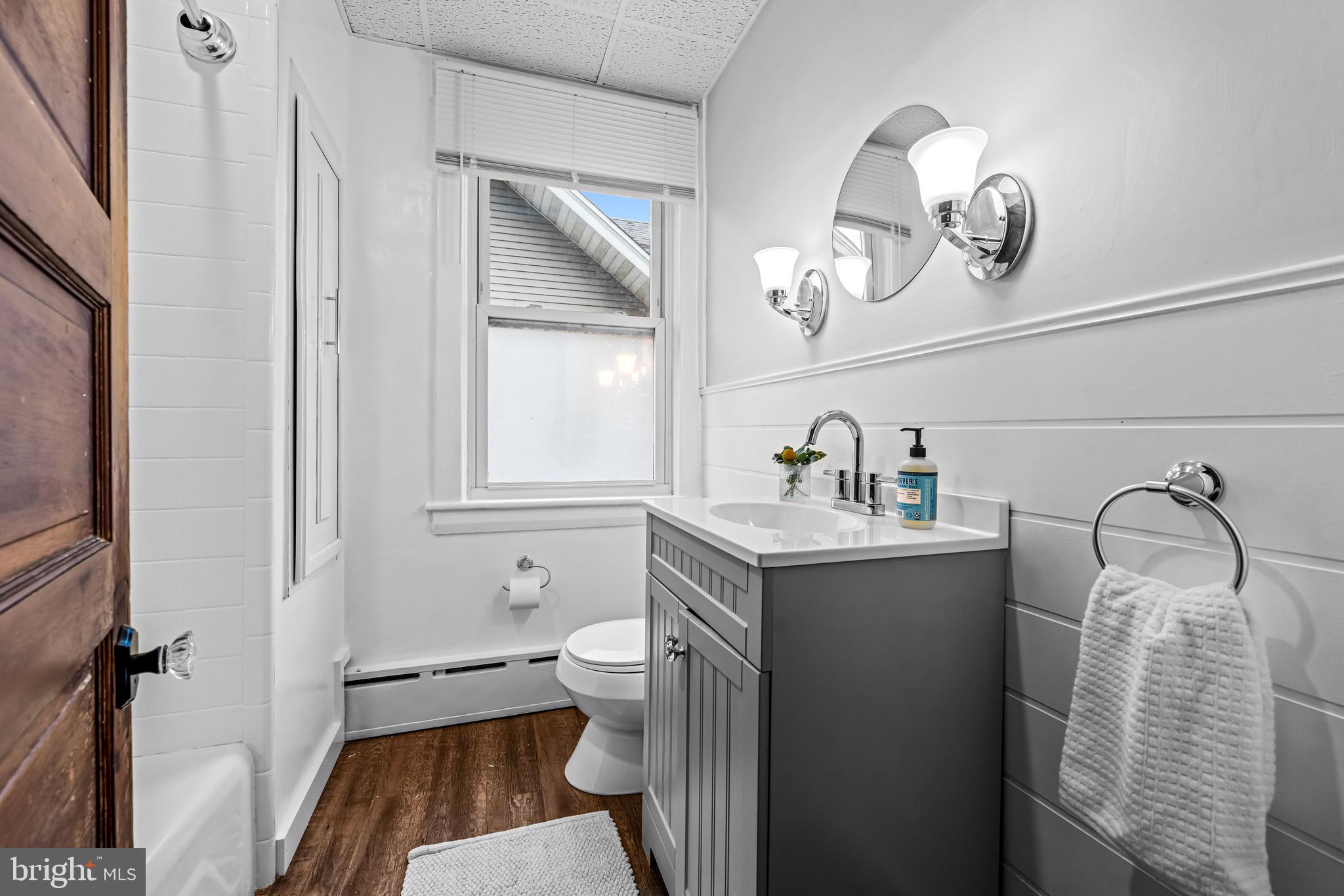 403 Midway Riverton, NJ 08077 - Photo 38 of 53 a bathroom with a sink a toilet and mirror