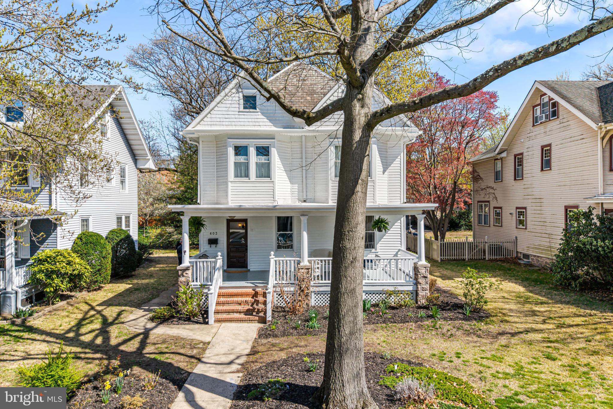 403 Midway Riverton, NJ 08077 - Photo 4 of 53 a view of a white house with a large tree and a yard