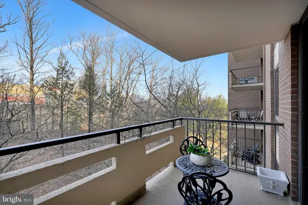 a view of a chairs and table in the balcony