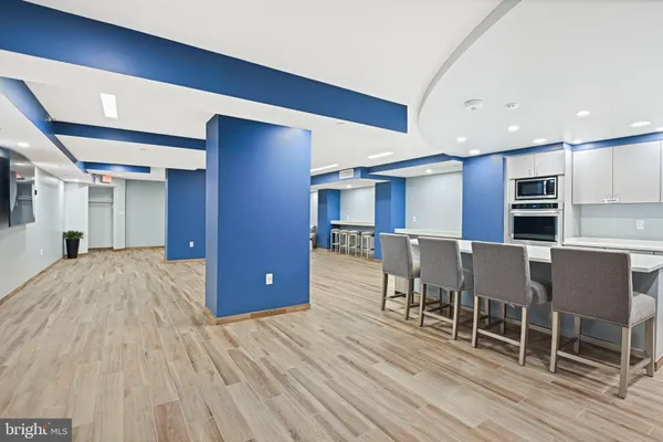 a open kitchen with stainless steel appliances granite countertop a refrigerator and a stove top oven