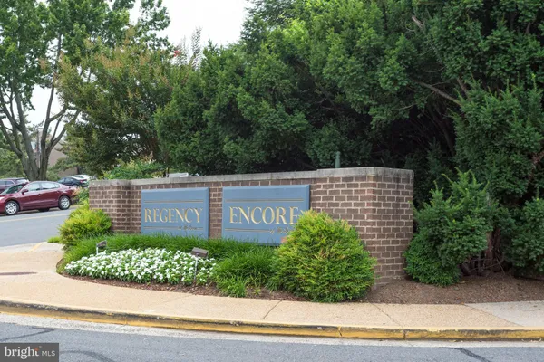 a sign that is sitting on a brick wall