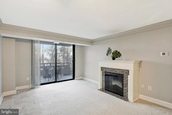 a view of an empty room with a fireplace