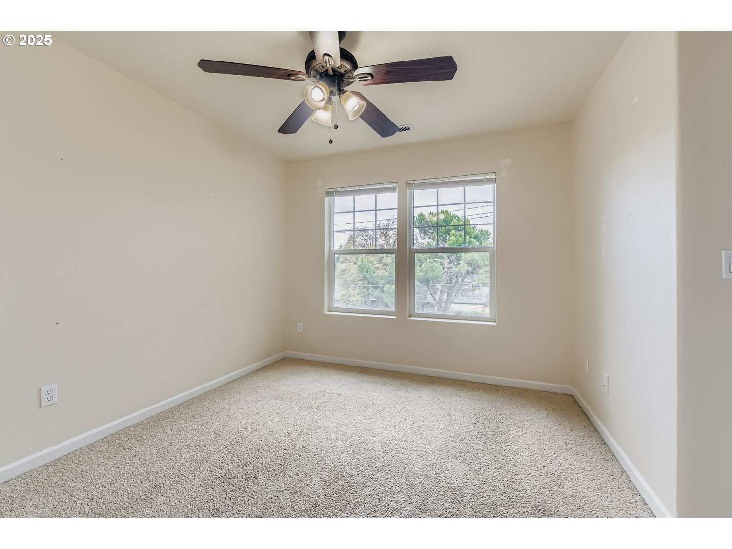 7912 Northeast Klickitat Street Portland, OR 97213 - Photo 18 of 29 an empty room with windows and fan