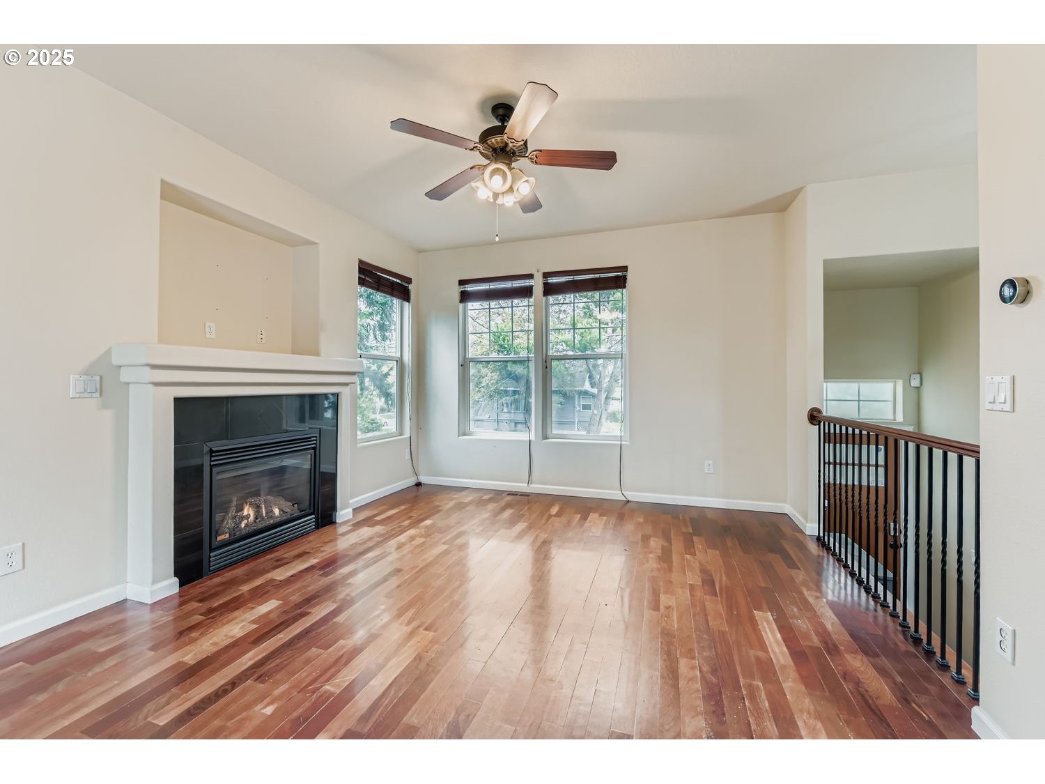 7912 Northeast Klickitat Street Portland, OR 97213 - Photo 5 of 29 a view of an empty room with wooden floor fireplace and a window
