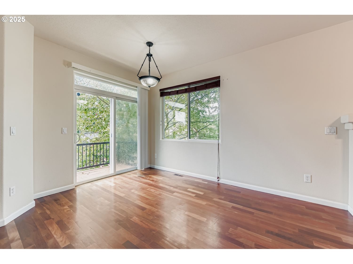 7912 Northeast Klickitat Street Portland, OR 97213 - Photo 7 of 29 a view of an empty room with wooden floor and a window