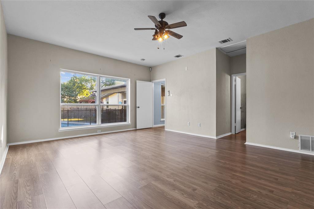 12218 Treeview Lane Farmers Branch, TX 75234 - Photo 14 of 17 a view of empty room with wooden floor and fan