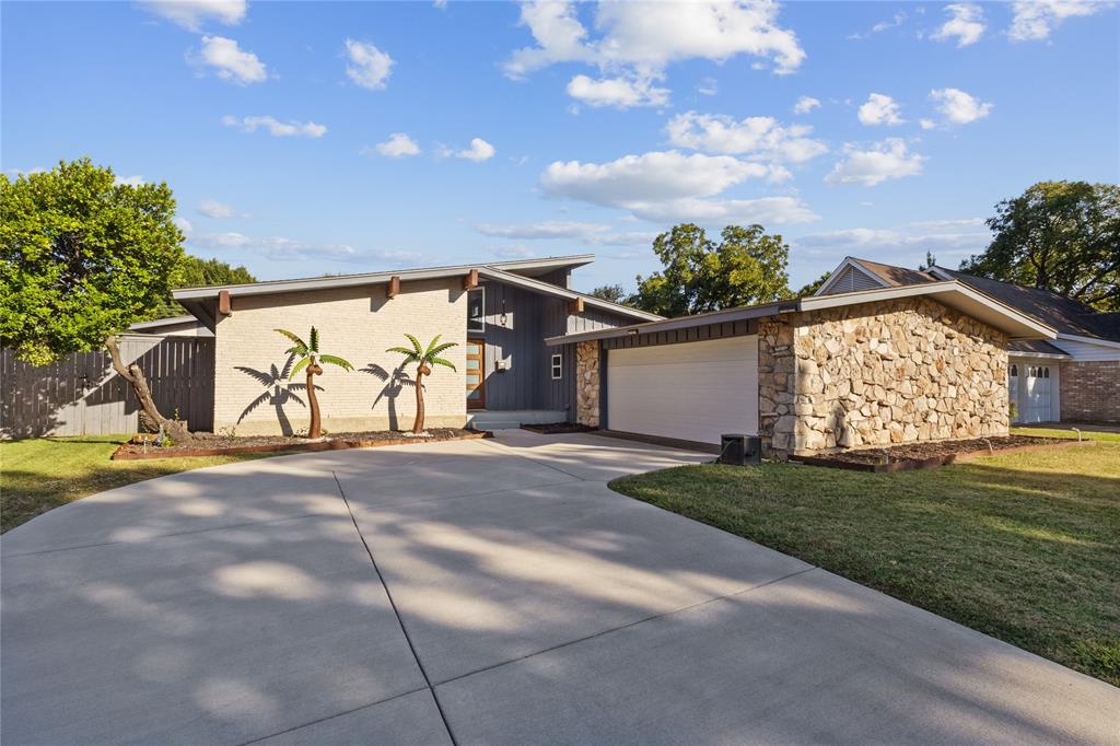 12218 Treeview Lane Farmers Branch, TX 75234 - Photo 3 of 17 a view of a house with backyard and a garage