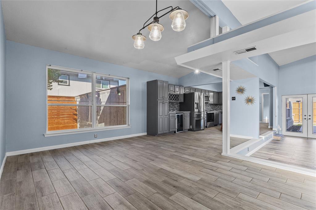 12218 Treeview Lane Farmers Branch, TX 75234 - Photo 8 of 17 an empty room with wooden floor cabinet and windows