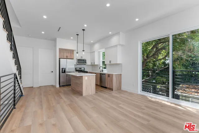 a kitchen with stainless steel appliances granite countertop a refrigerator sink and cabinets