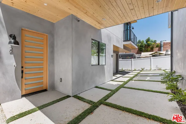 a view of a backyard with chair and a potted plant