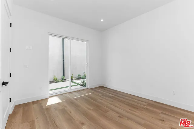 a view of room with wooden floor and window