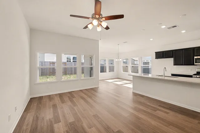a view of kitchen with sink and wooden floor