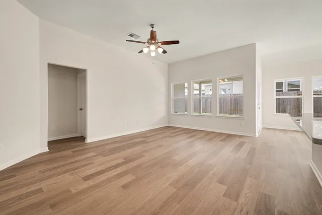 wooden floor in an empty room with a window