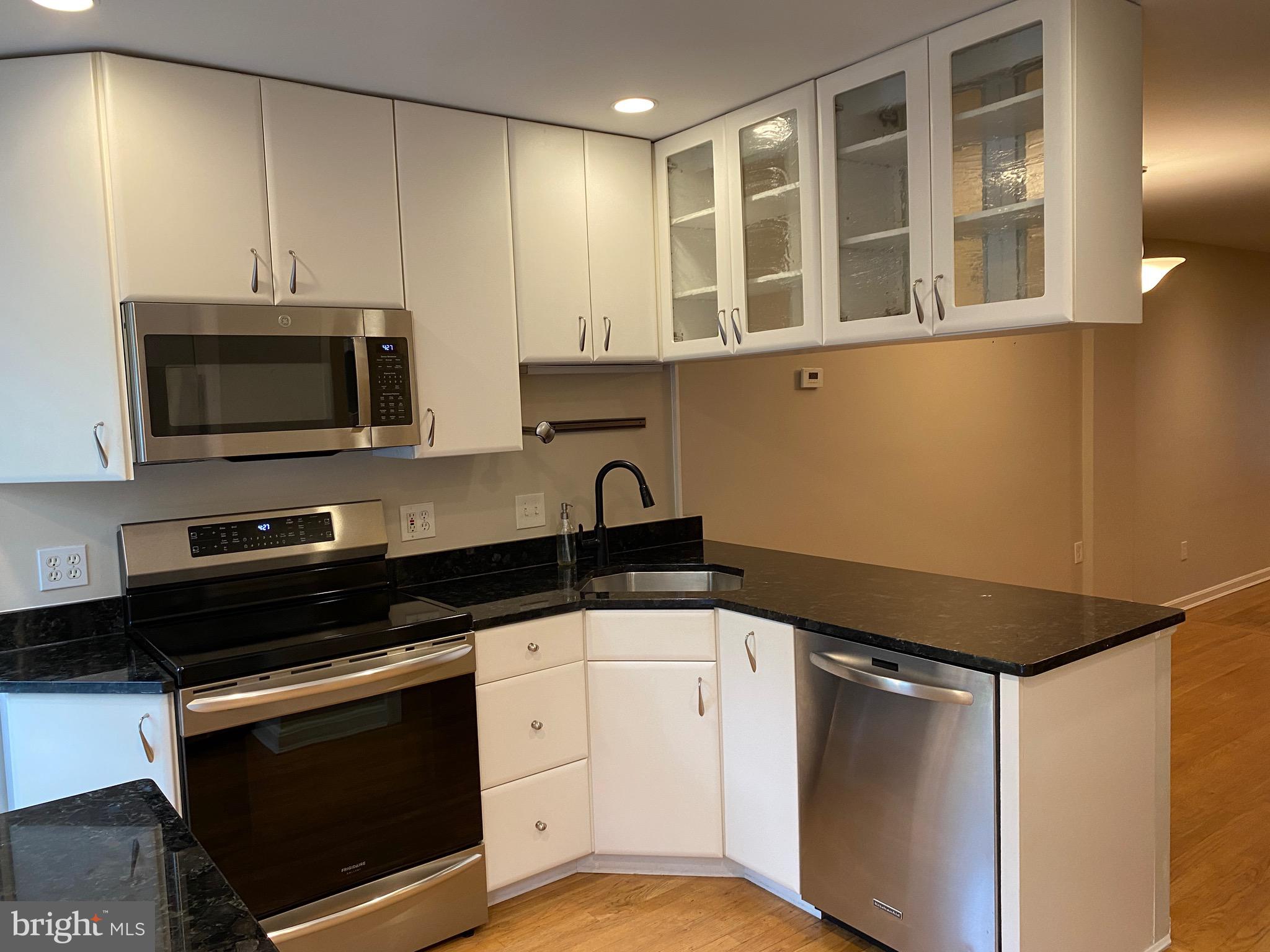 339 11th Street Southeast Washington, DC 20003 - Photo 20 of 39 a kitchen with stainless steel appliances a stove microwave and sink