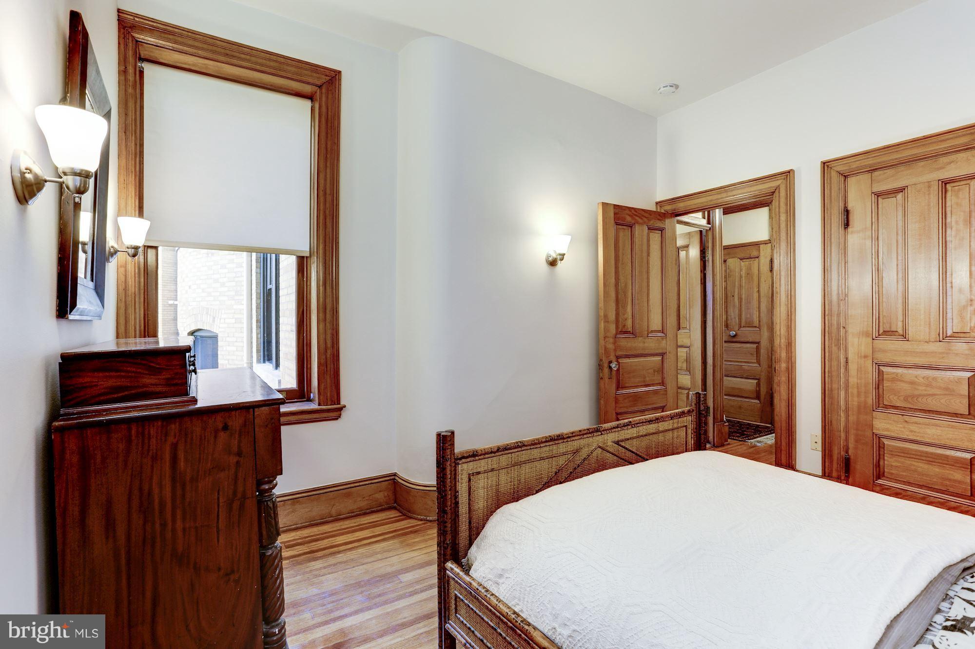 2220 20th Street Northwest, Unit 57 Washington, DC 20009 - Photo 15 of 27 a bedroom with a bed and a mirror on dresser