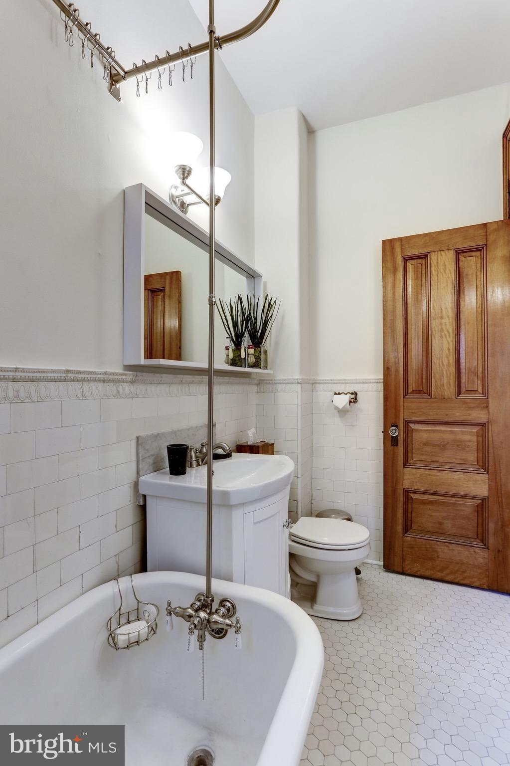 2220 20th Street Northwest, Unit 57 Washington, DC 20009 - Photo 17 of 27 a bathroom with a sink a toilet and shower