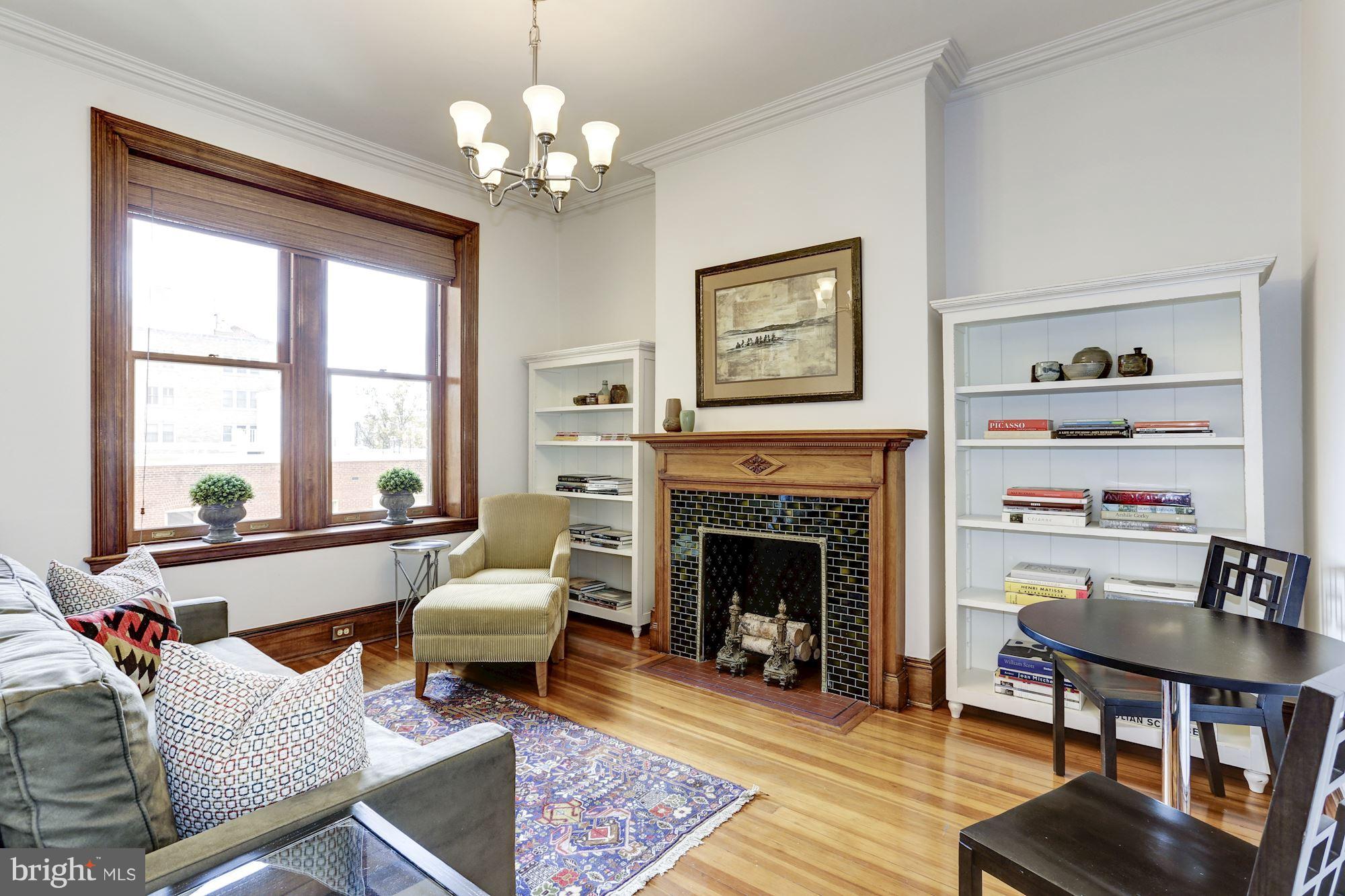 2220 20th Street Northwest, Unit 57 Washington, DC 20009 - Photo 7 of 27 a living room with furniture a chandelier and a fireplace
