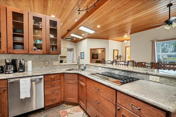 a kitchen with granite countertop a sink and cabinets