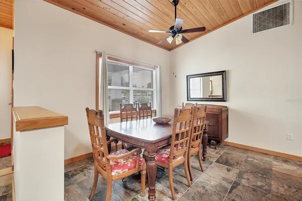 a dining room with furniture and window
