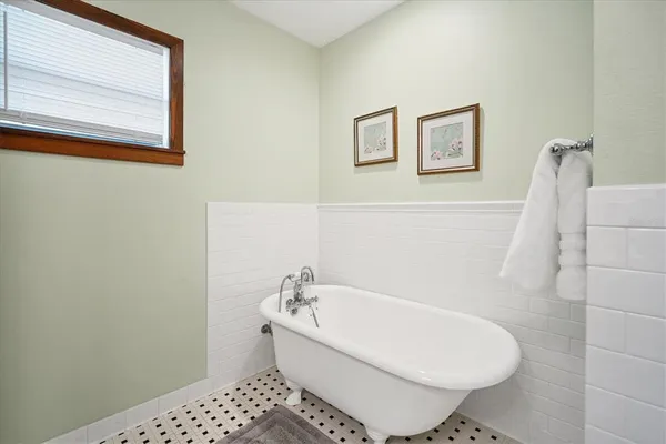 a white bath tub sitting next to a white sink