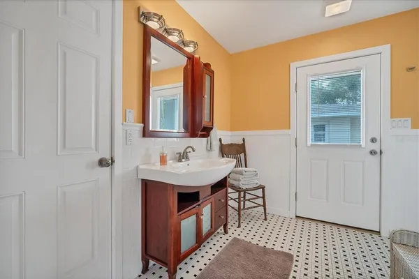 a bathroom with a sink a mirror and a shower