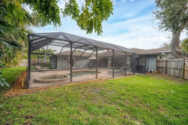 a view of a house with backyard and sitting area