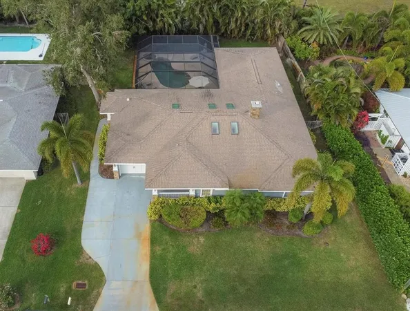 an aerial view of a house with a yard